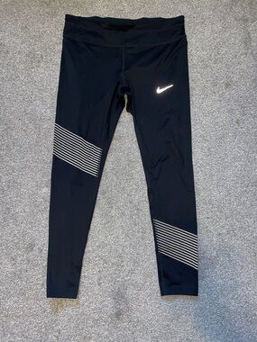 Nike Dri-Fit Black Leggings with White Striped Knee Panels and Reflective Swoosh